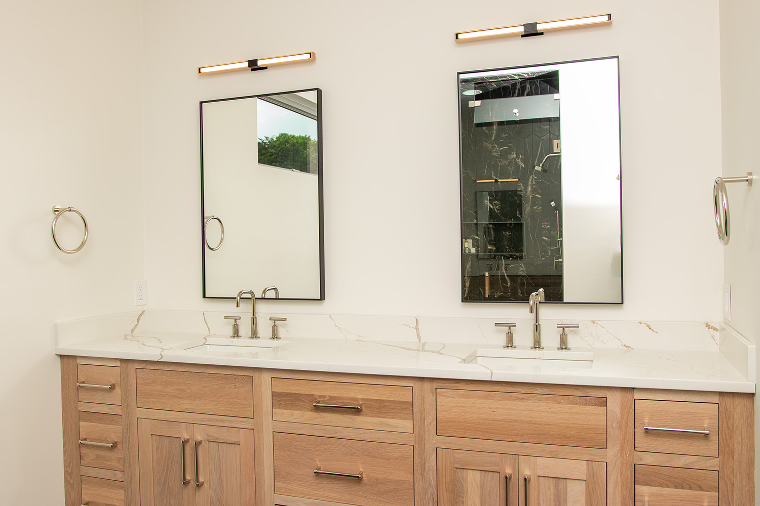 Serene master bathroom vanity featuring a coastal palette and natural textures, part of a new construction project in Tiverton, RI.