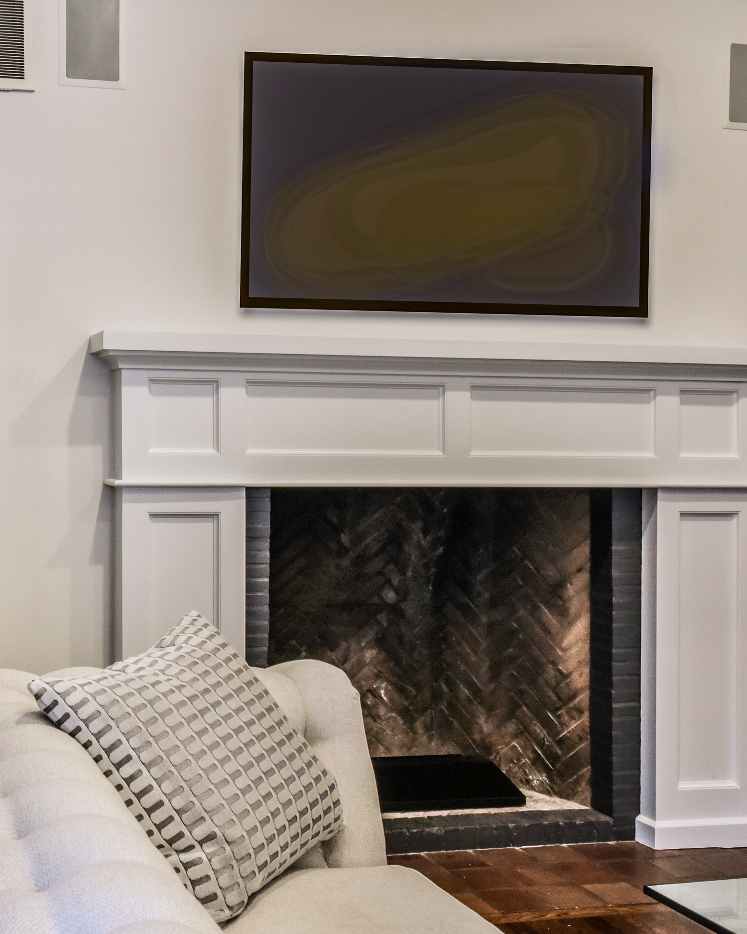 Renovated fireplace featuring a custom white mantel and restored herringbone brick firebox.