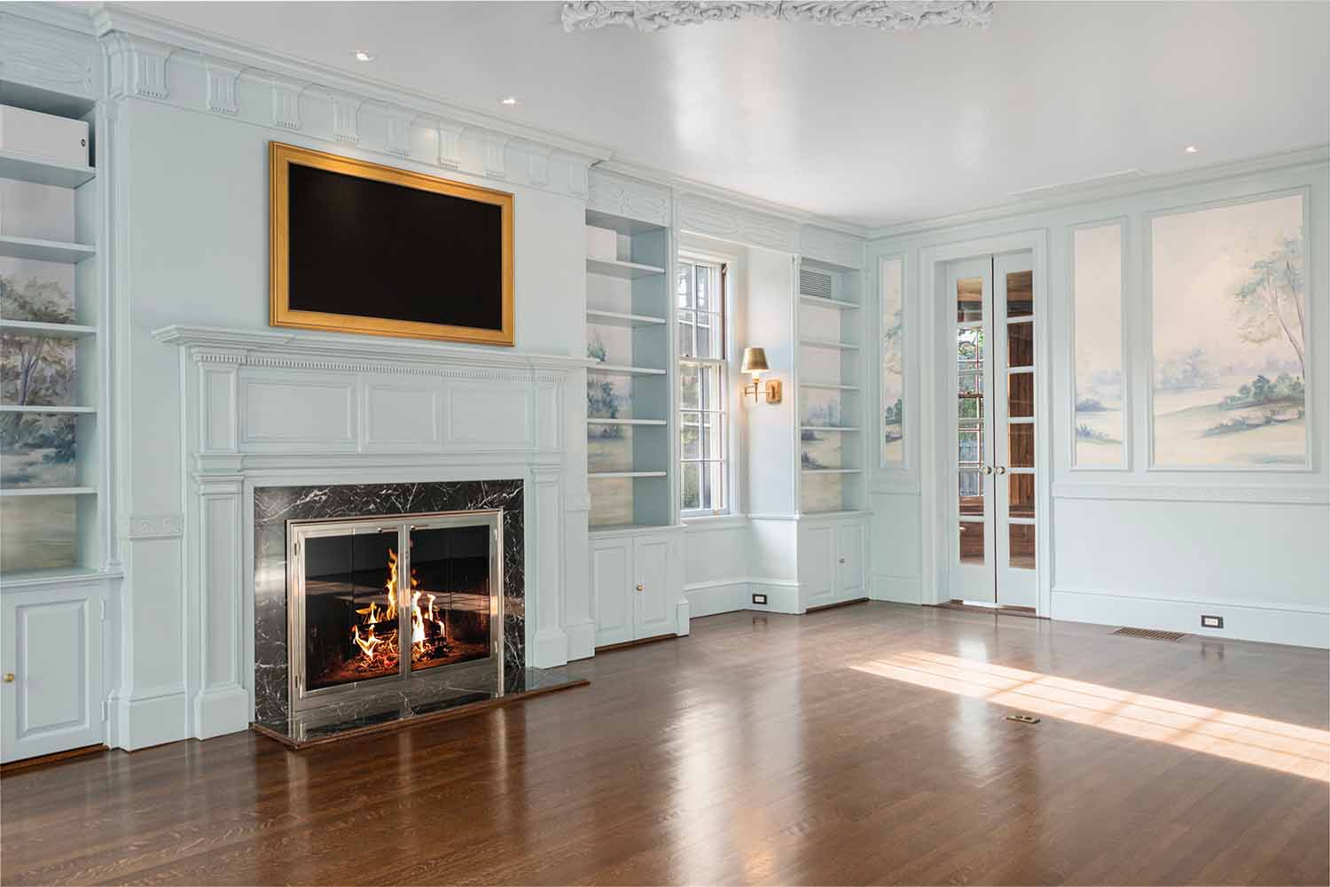 Spacious formal living room with restored historic millwork, blue walls, and a custom fireplace mantel.