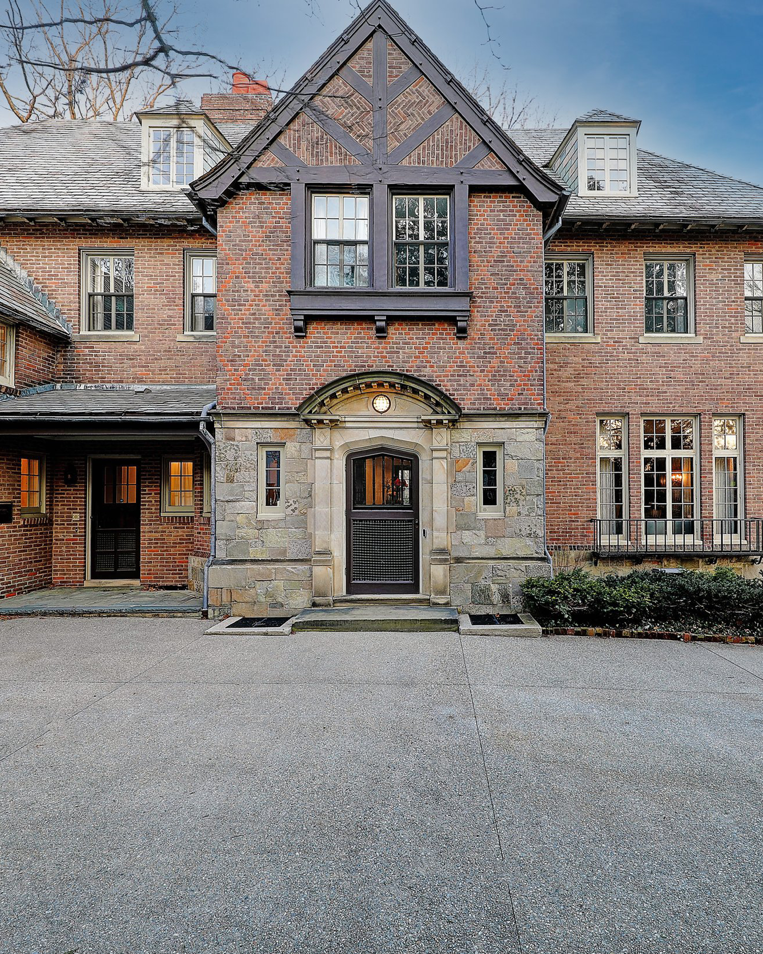 Detail of the stone portico and brick facade of a renovated historic estate in Providence, RI.