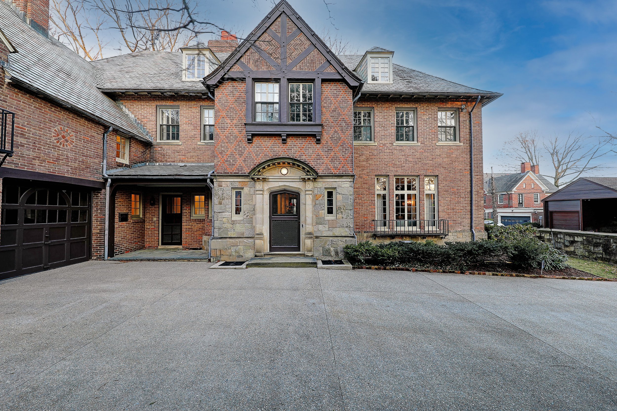 Exterior view of the historic Cherry-Hallworth House on Freeman Parkway in Providence, RI, featuring restored brickwork and original architecture.
