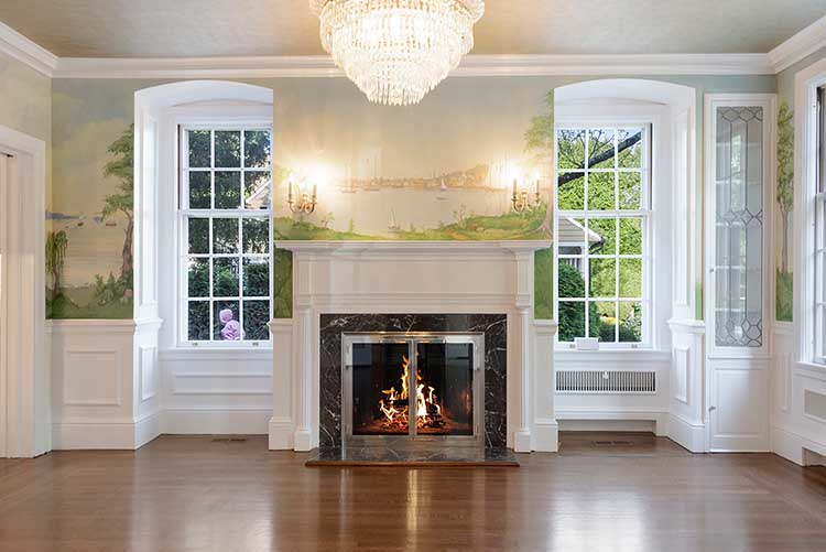 Show-stopping kitchen renovation featuring an original fireplace, marble countertops, and a relocated layout for modern living.