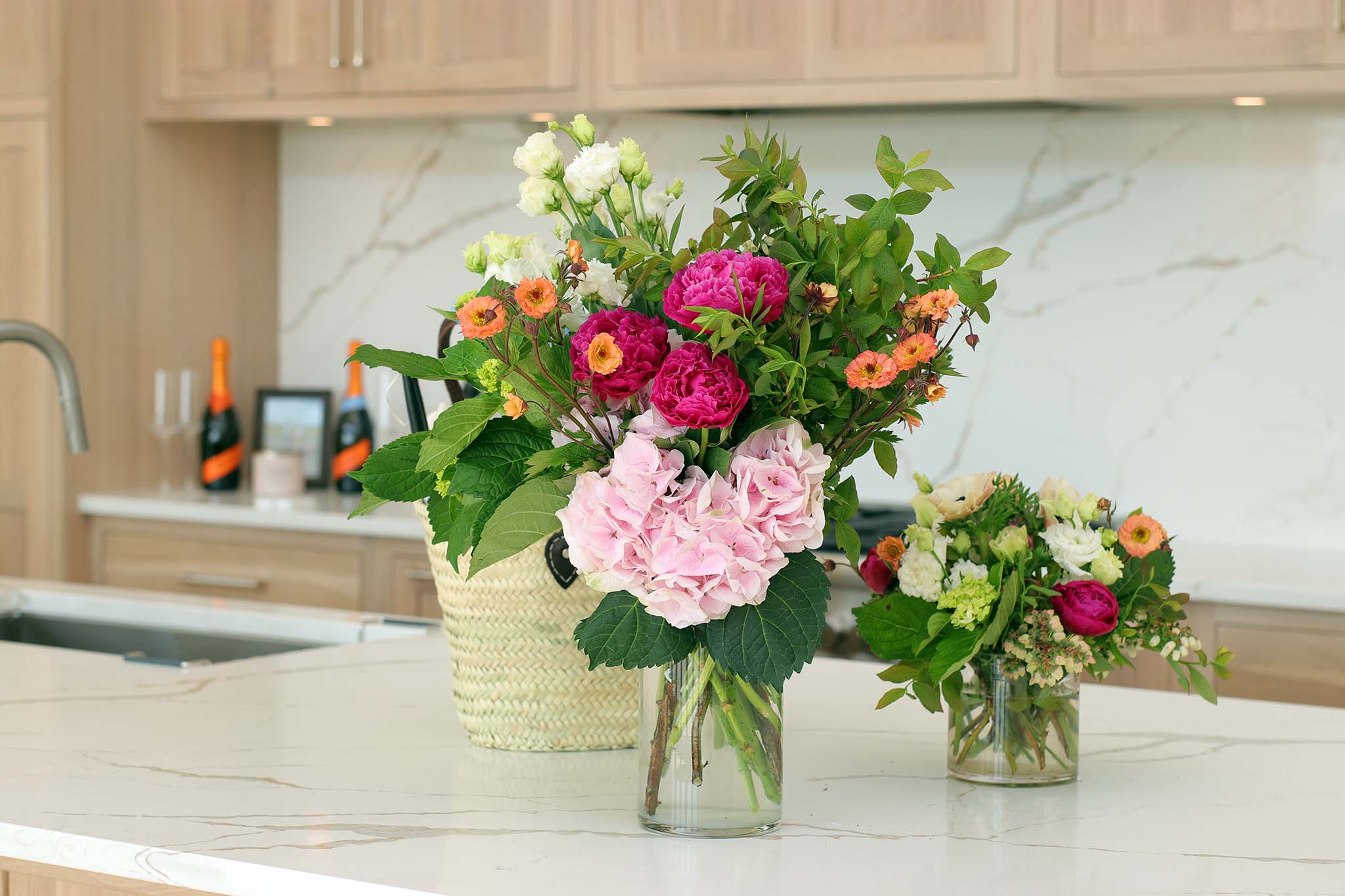 Detail of the kitchen island stone and floral styling, highlighting the use of natural textures in this custom modern home.