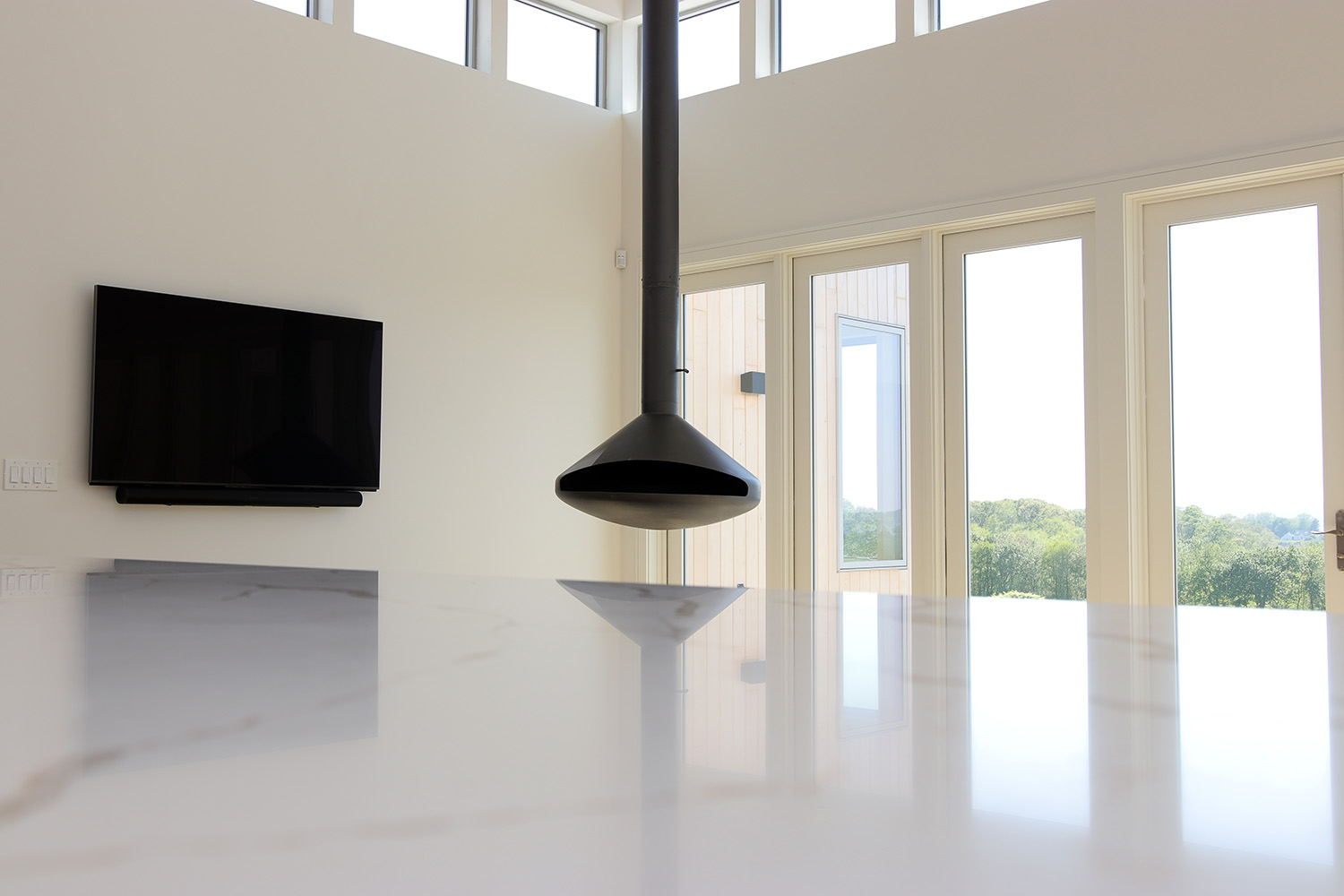 Open-concept living space designed to maximize river views and natural light, blending contemporary living with New England charm.