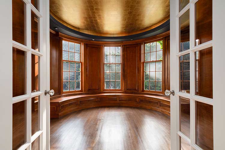 erfectly preserved original wood paneling and bench seating in a historic East Side home bay window.