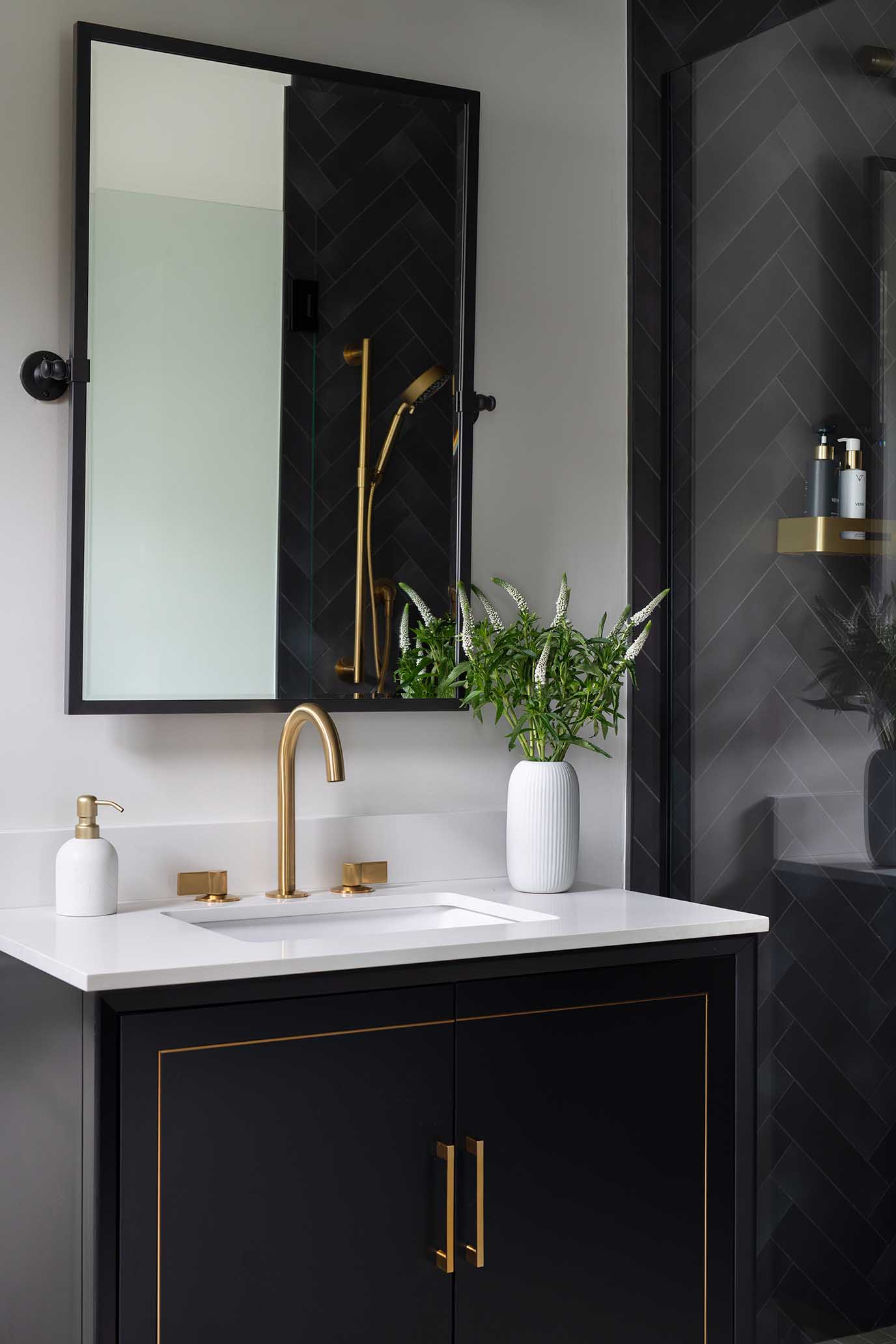 Bright, clean guest bathroom design with a white vanity and modern coastal fixtures.