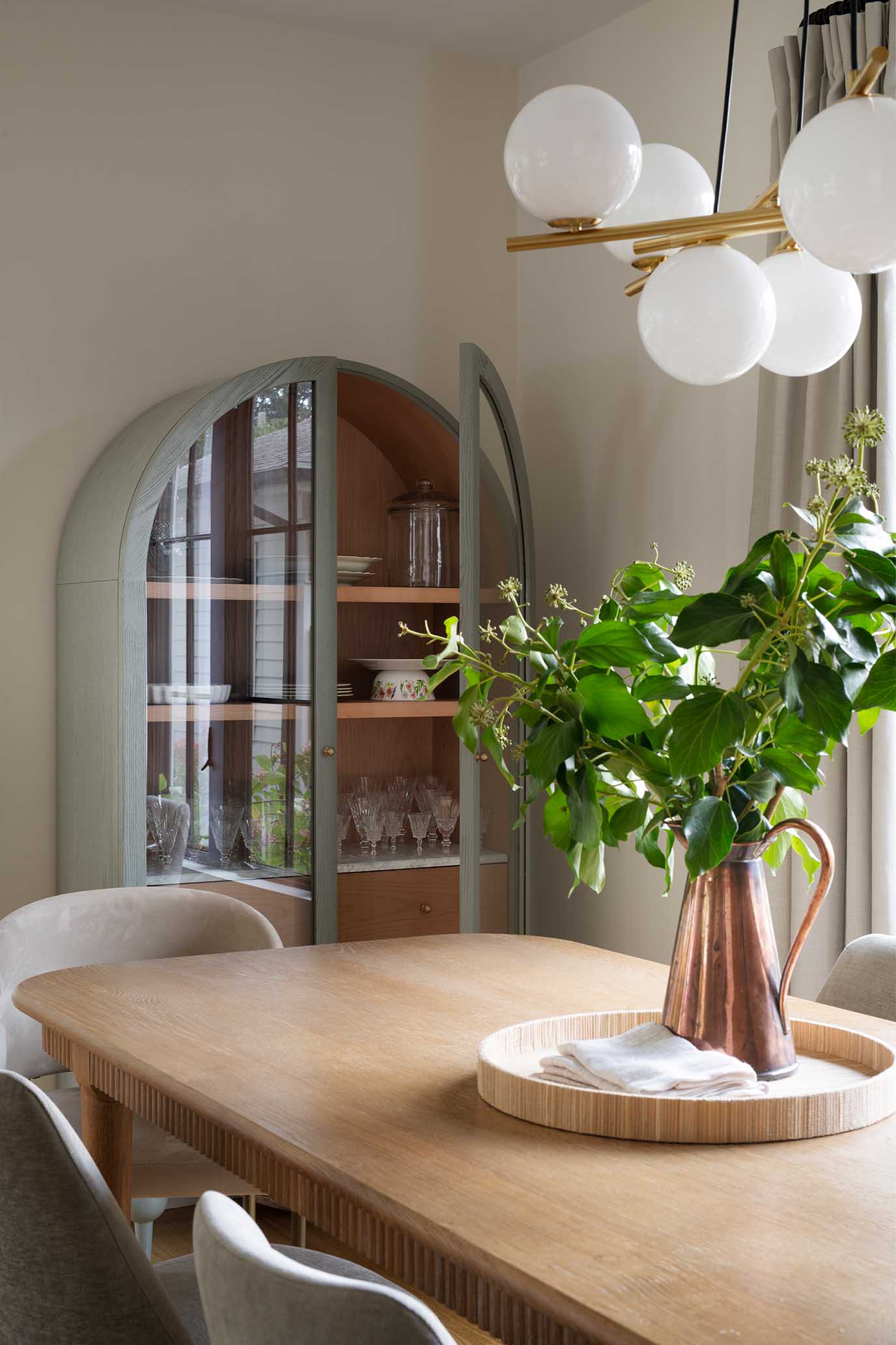 Architectural detail of a custom arched built-in shelf with white oak accents.