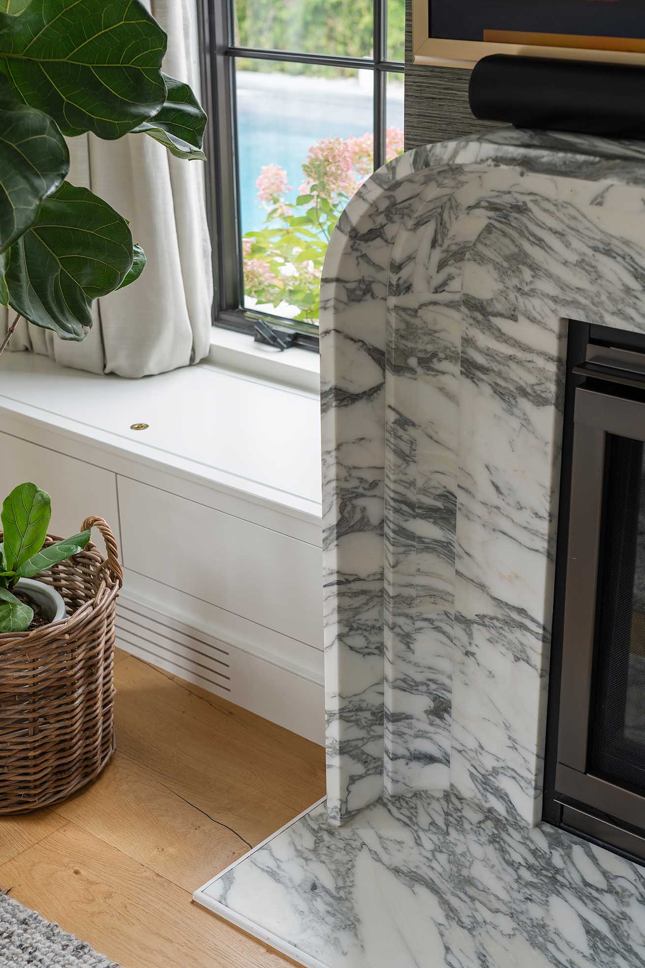 Detail of the custom stone fireplace surround, a focal point of the modern coastal living room.