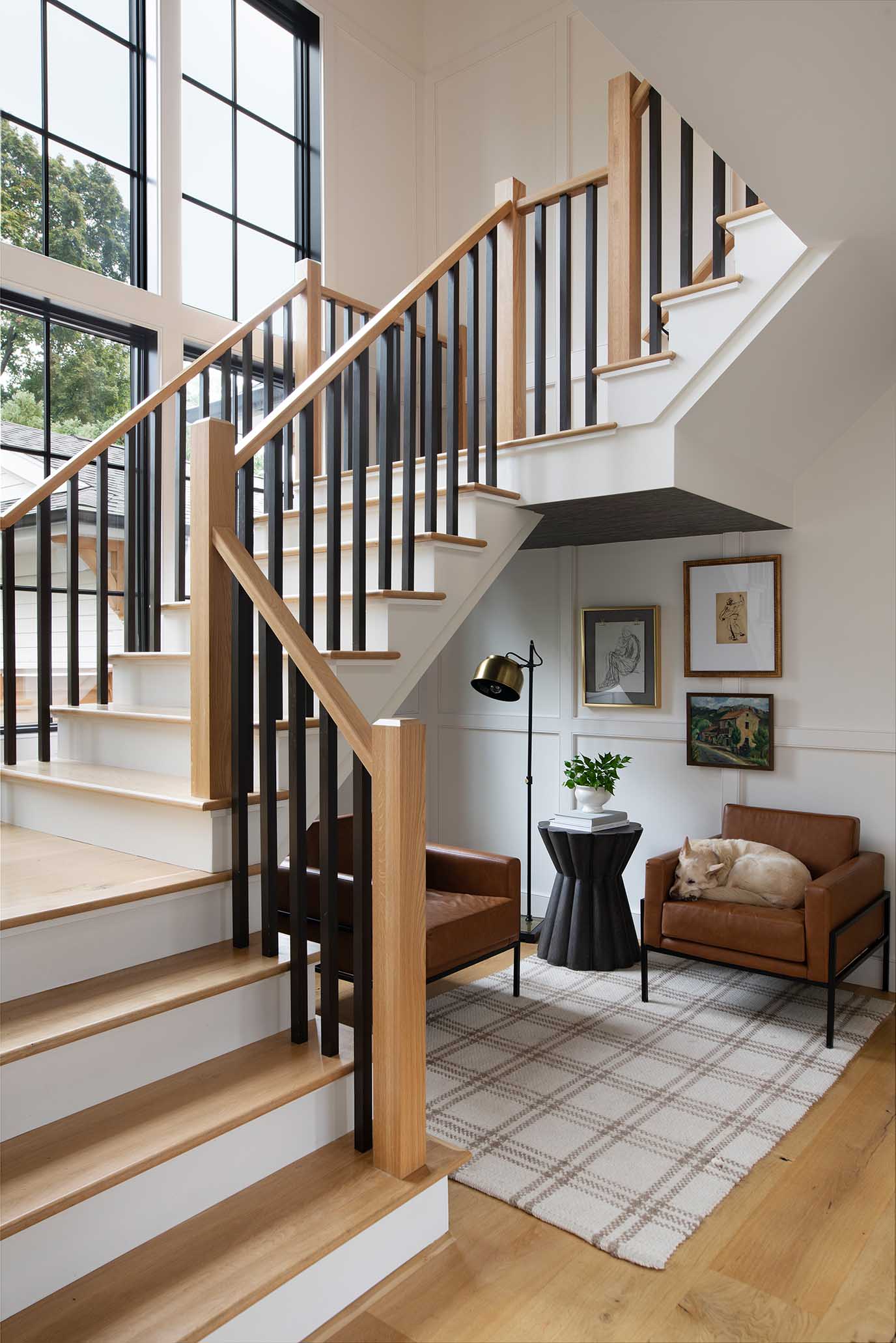 A modern-traditional staircase design, showcasing the integrated design-build process that seamlessly connects architectural planning with interior craftsmanship.