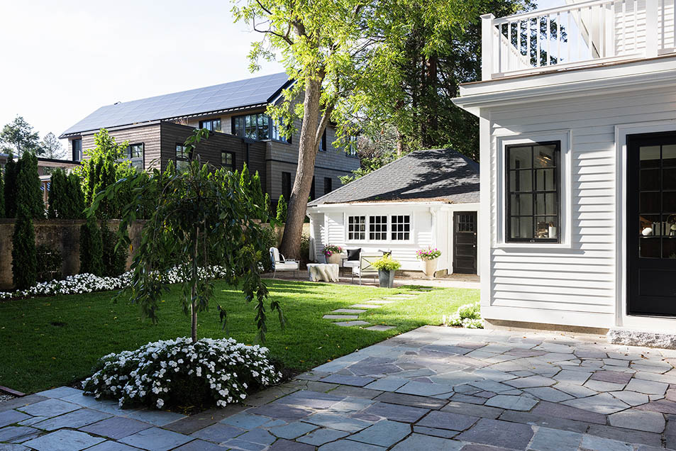 View of the detached garage and guest studio, matching the architectural style of the main house.