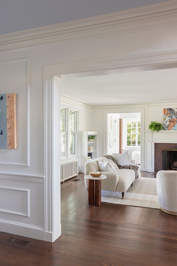 Elegant transition from the foyer to the formal living room, framed by classic architectural moldings.