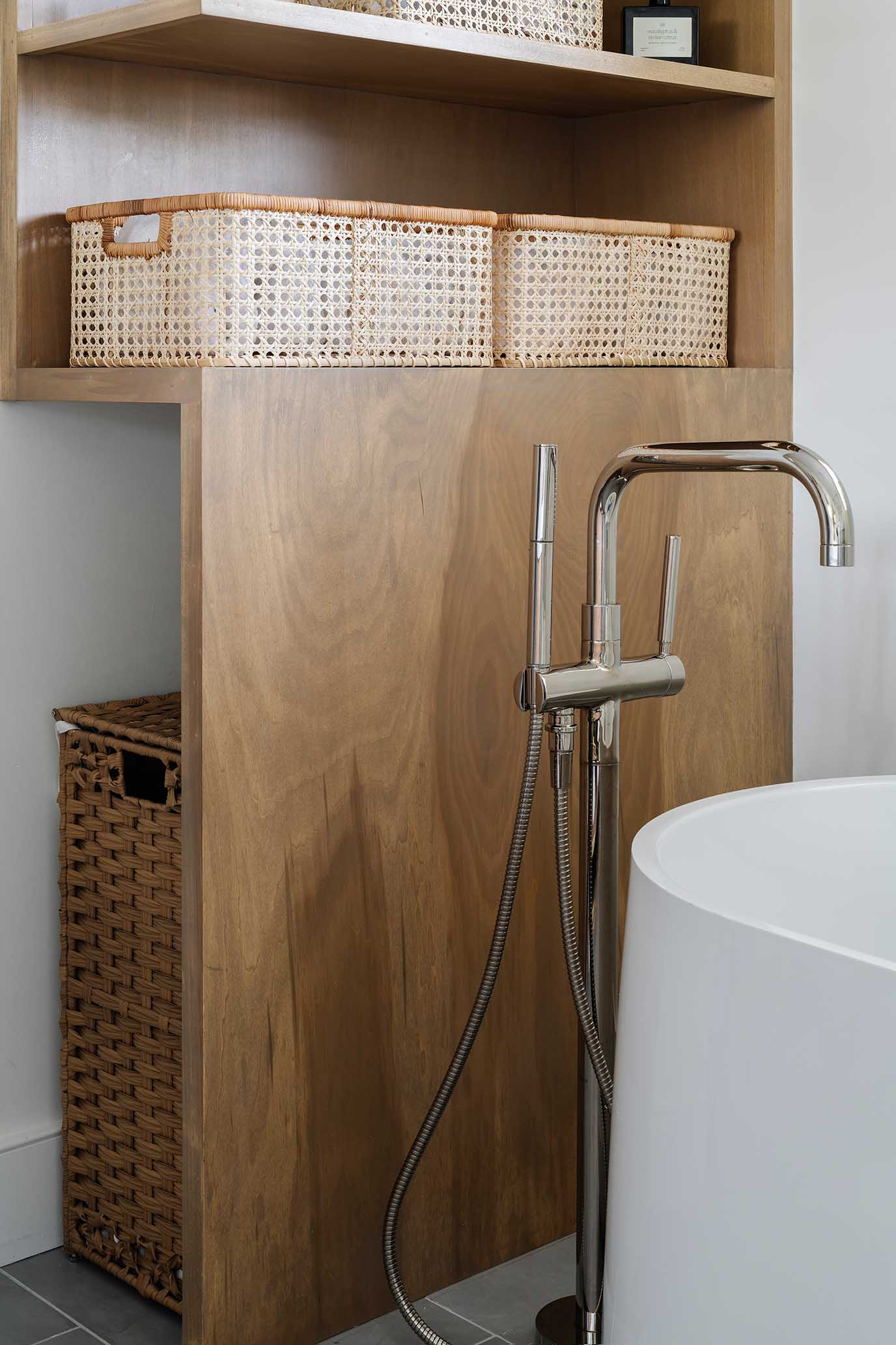 Close-up of a modern floor-mounted tub filler and soaking tub, a key feature in luxury bathroom renovations.