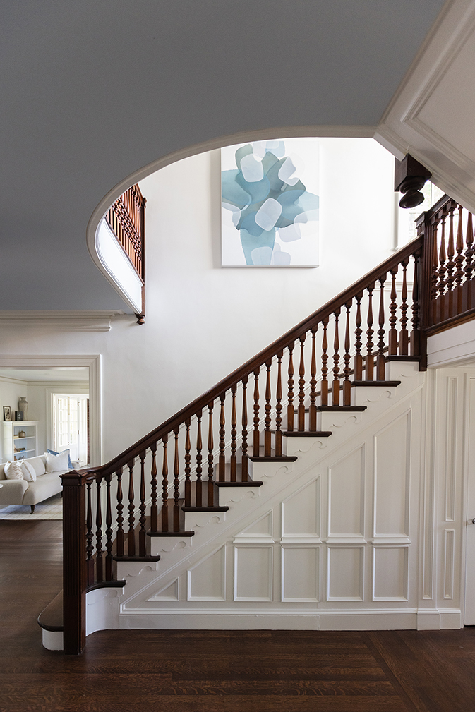 Majestic main staircase renovation, preserving the original millwork and grand scale of the 1911 home.