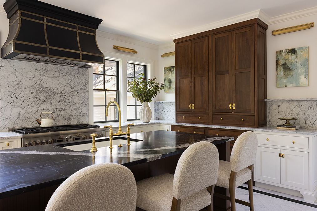 Expansive chef's kitchen renovation in a historic Providence home, featuring a large center island and custom range hood.