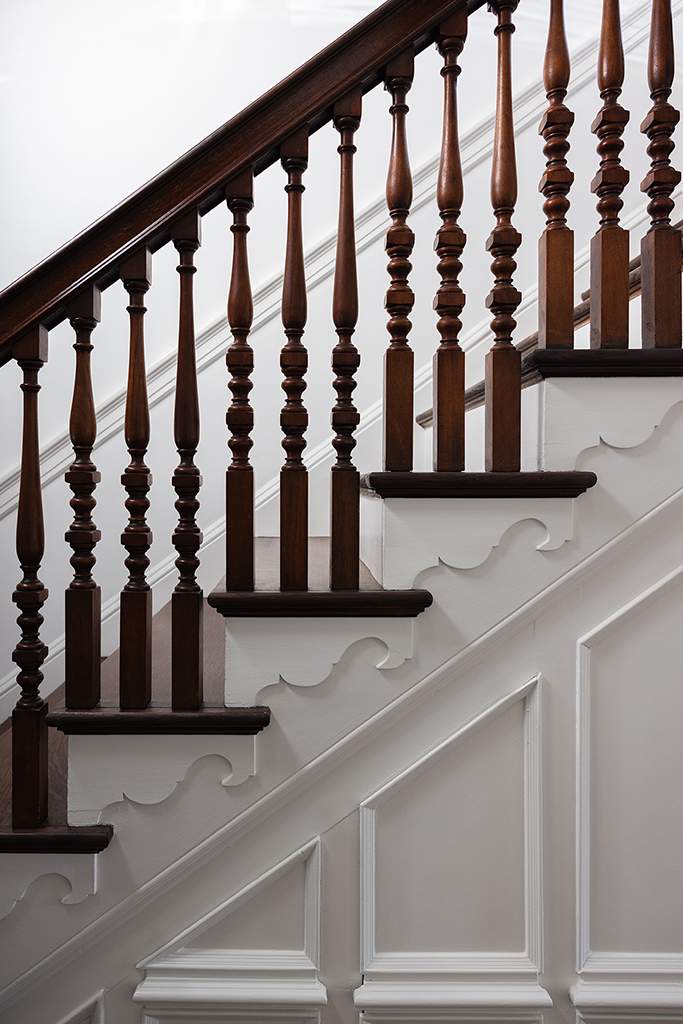 Close-up of the intricate turnings on the historic staircase balusters.