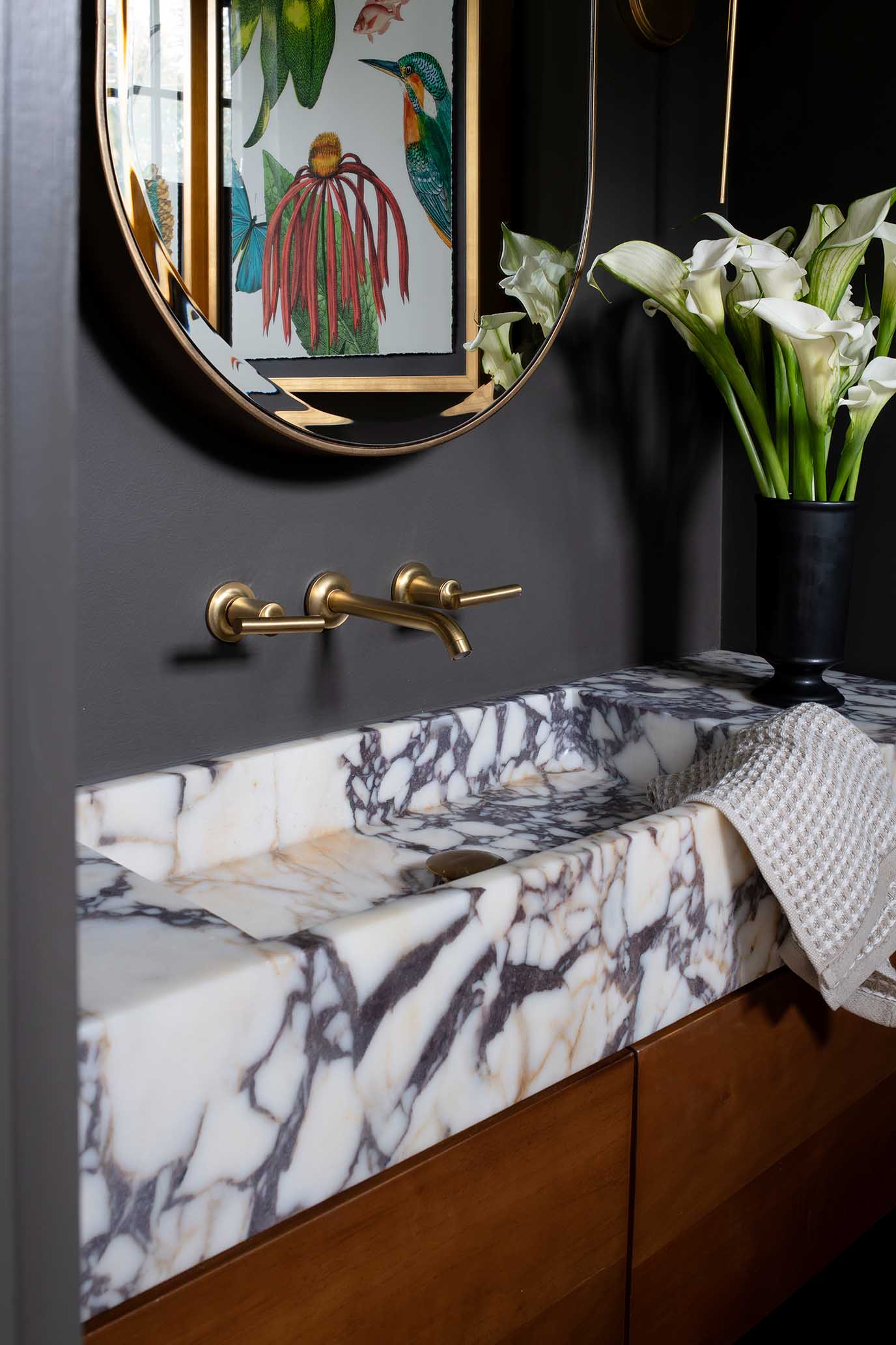 Floating marble vanity with brass fixtures, a luxury detail typical of high-end custom home builders in Rhode Island.