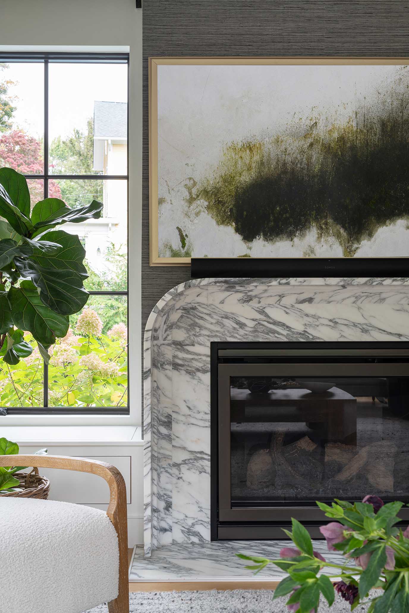 Close-up of a custom marble fireplace surround, highlighting the high-end materials used in this historic district renovation.