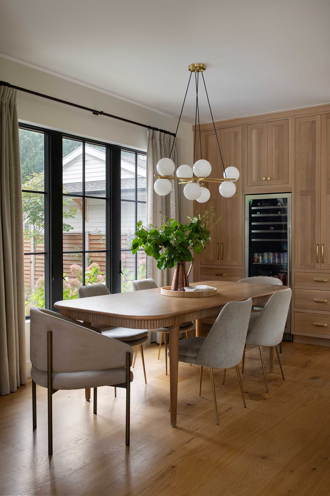Elegant dining area featuring a built-in wine fridge and custom millwork, seamlessly integrated by the design-build team.