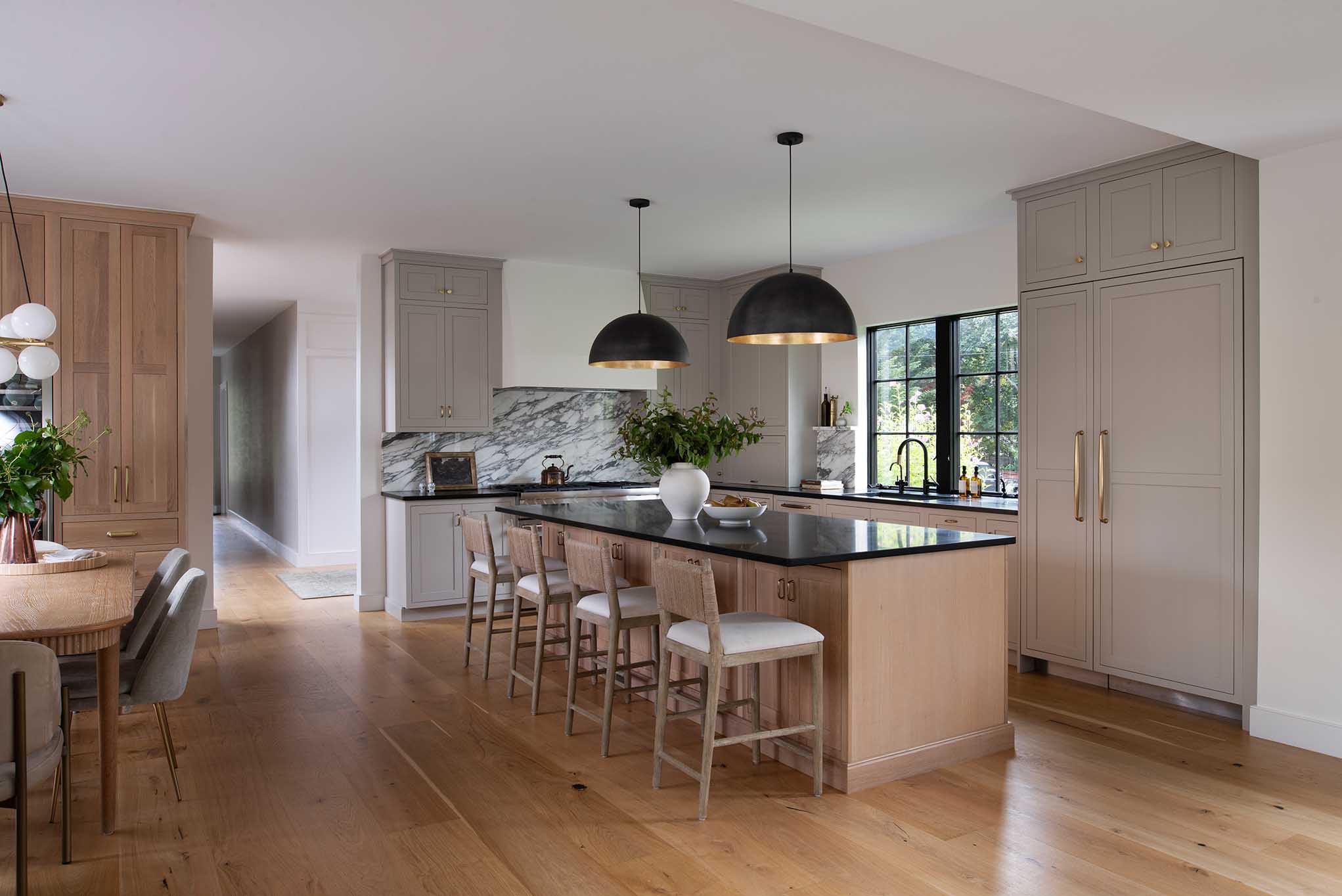 Wide view of an open-concept floor plan connecting the kitchen and dining areas, a popular request for Rhode Island home renovations.