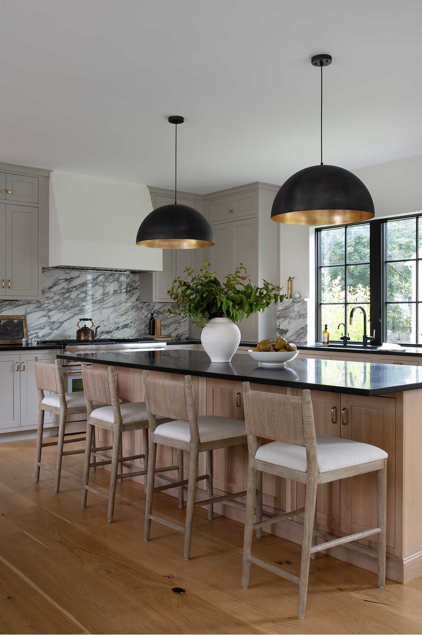Expansive kitchen island with seating, designed for family gathering and entertaining in an East Greenwich custom home.