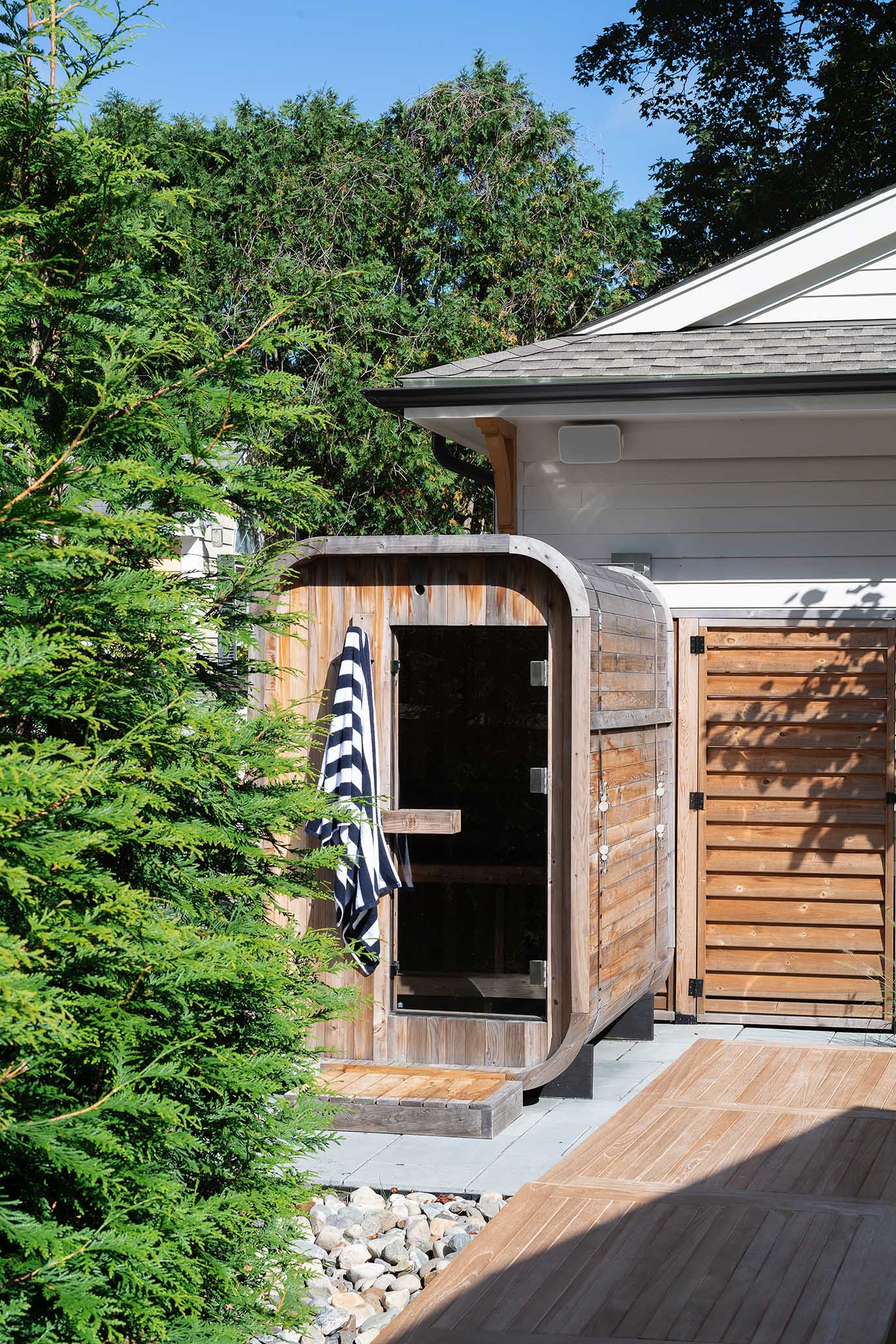 Custom outdoor cedar sauna designed by Hill & Harbor, part of a wellness-focused new construction project in East Greenwich, RI.