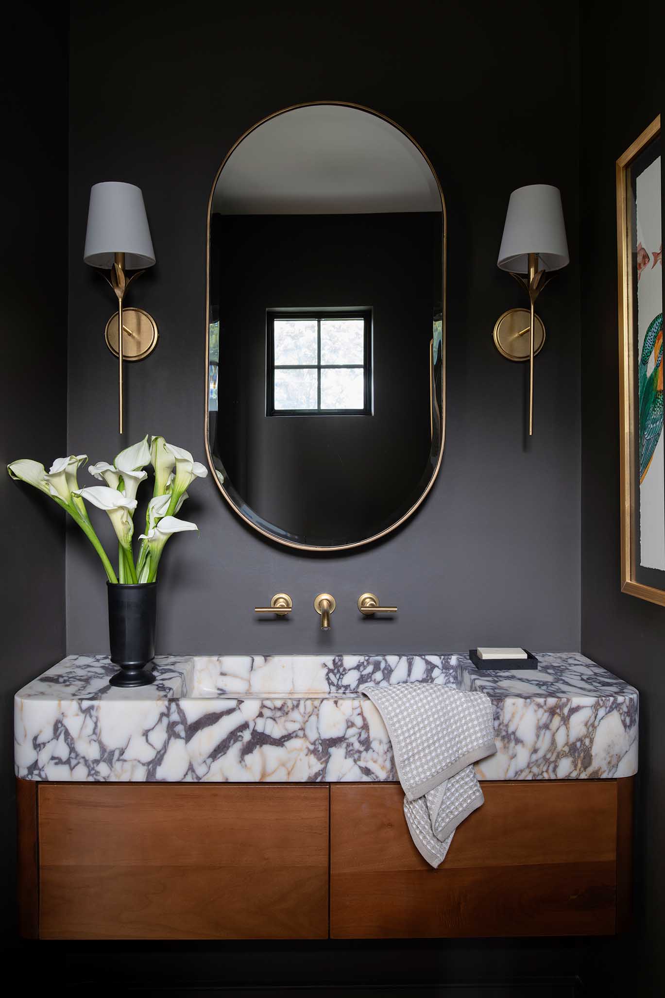 Moody, sophisticated bathroom vanity featuring natural stone, showcasing the material selection expertise of Hill & Harbor.