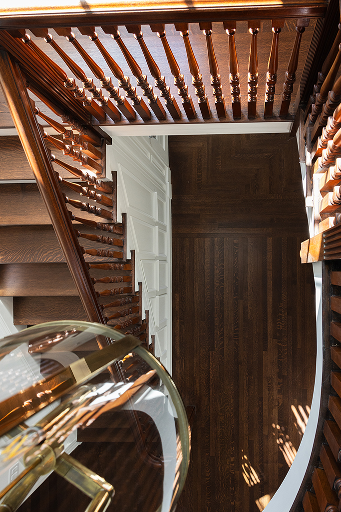 Artistic overhead view of the winding staircase, showing the architectural geometry of the home.